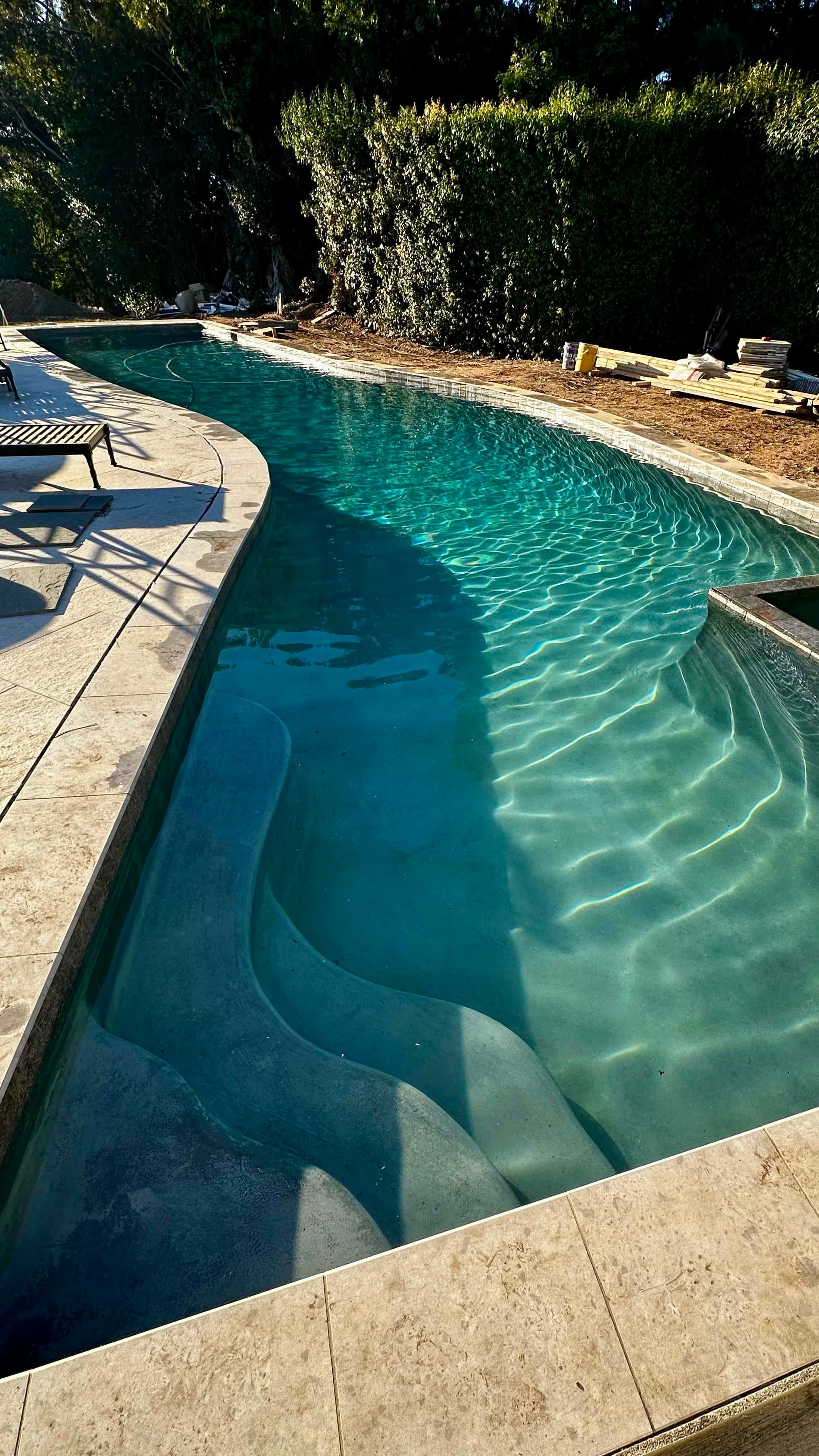 Clean curved pool with stone deck
